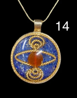 Decorative pendant with blue and gold design on a black background