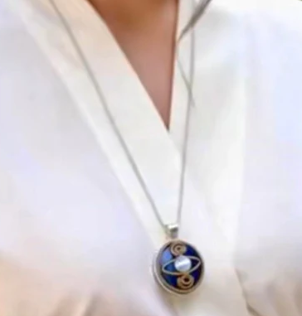Close-up of a necklace with a pendant on a white background