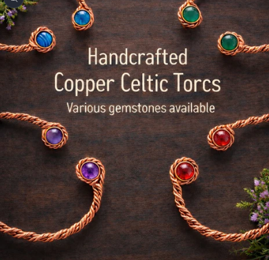 Handcrafted copper Celtic torcs with various gemstones on a dark surface