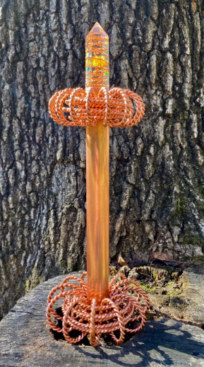  copper wire wrapping against a tree bark 