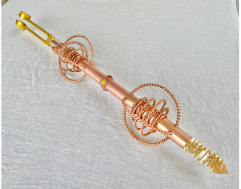 Copper and gold decorative item on a white background