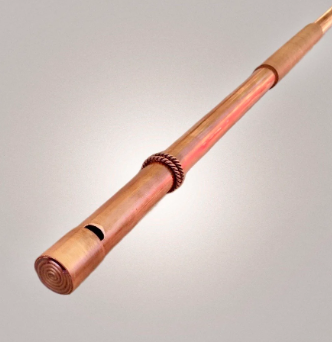 Copper flute on a light gray background