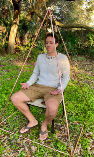 Person meditating in golden ration pyramid